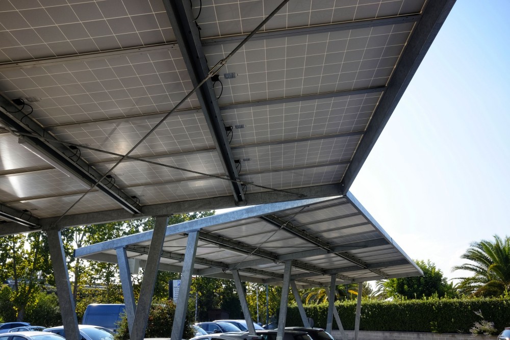 Photo de 2 ombrières, de grands panneaux solaires utilisés comme toit couvrant dans un parking